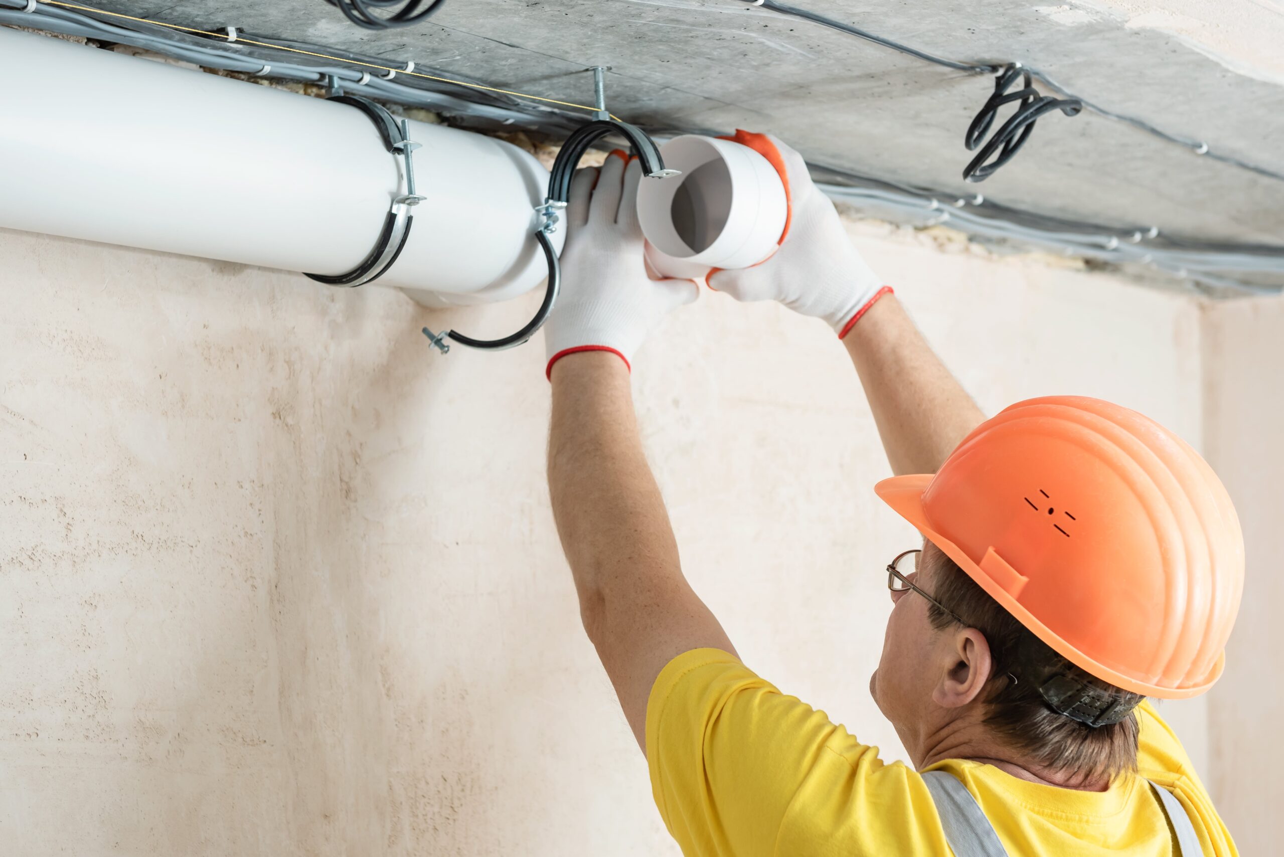 worker-is-installing-ventilation-system-apartment-min